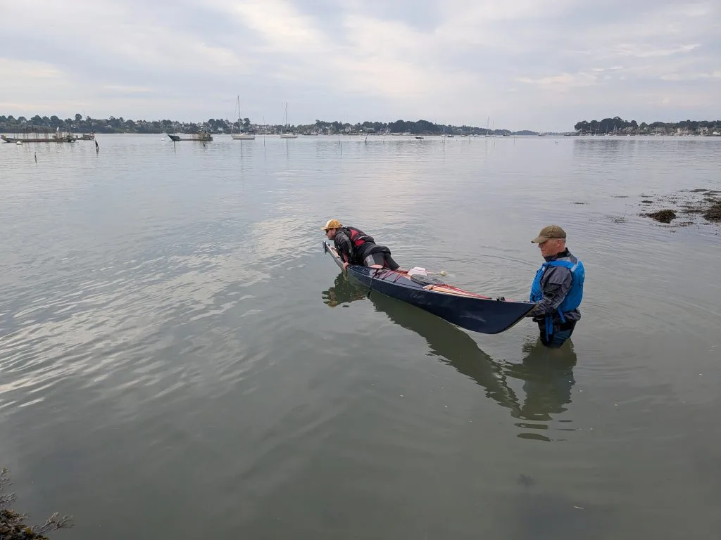 Re-entering a kayak in open water.